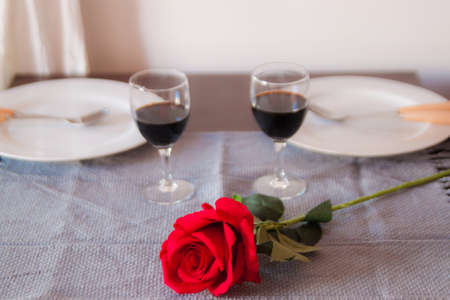 Couple Making A Toast At A Romantic Dinner On Restaurant Table With Red Rose.の写真素材