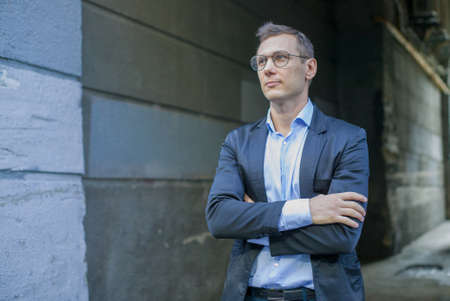 Successful businessman in a suit with glasses in the city