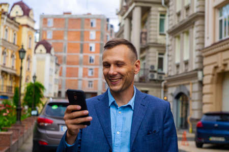 Successful businessman in a suit with glasses in the city