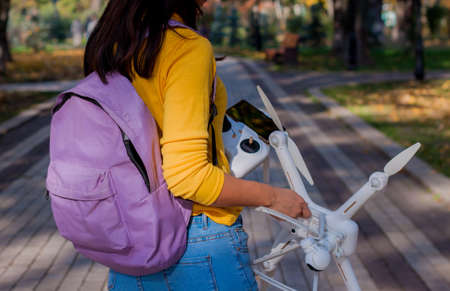 The UAV drone and Tourist hands close-up. Asian woman traveling with drone