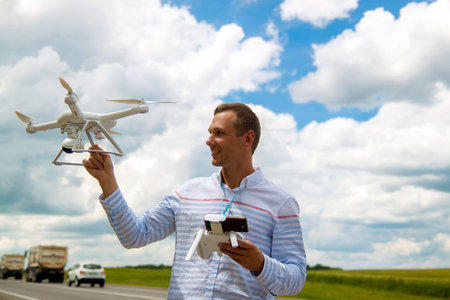 The UAV drone and photographer man hands close-up.drone copter flying with digital camera. Flying...