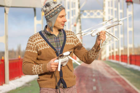 The UAV drone and photographer man hands close-up.drone copter flying with digital camera. Flying...