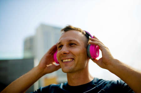 Close up portrait of good-looking sport guy spending time outdoors and expressing positive emotionsの写真素材