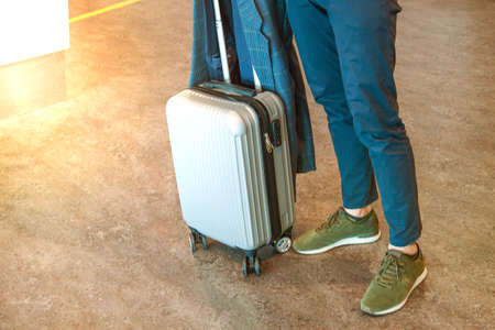 Unrecognizable Man With Hand Luggage Walking In Airport Terminalの写真素材