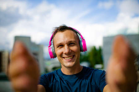 Close up portrait of good-looking sport guy spending time outdoors and expressing positive emotionsの写真素材