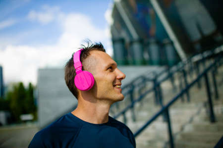 Close up portrait of good-looking sport guy spending time outdoors and expressing positive emotionsの写真素材