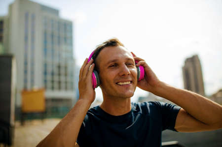Close up portrait of good-looking sport guy spending time outdoors and expressing positive emotions
