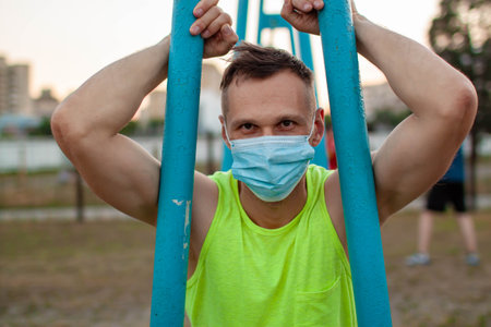 Young man in mask Trying To Do Sport During pandemic