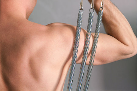 Muscular man go in for sports. A very fit young man kneading his muscles.