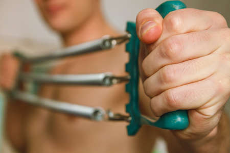 Muscular man go in for sports. A very fit young man kneading his muscles.