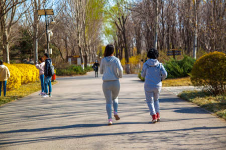 A Family, mother and daughter runner outdoors.