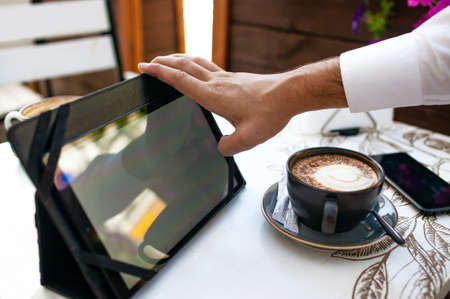 Caucasian Businessman Using Digital Tablet In Cafe