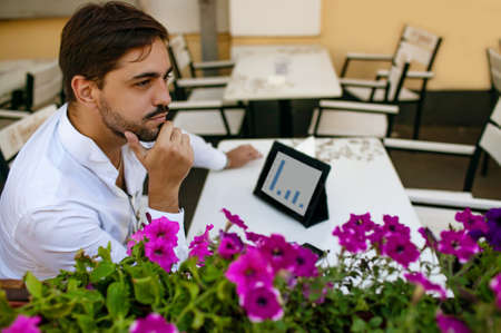 Caucasian Businessman Using Digital Tablet In Cafe