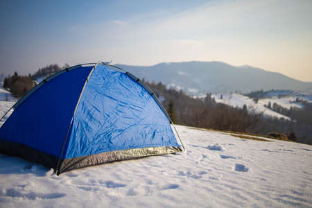 Winter Camping On Snow In The Forest. Blue Tent On Hill.の写真素材