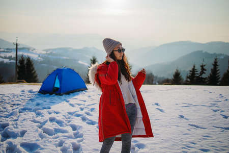 Tourist Asian Woman In Forest In Winter Mountains Near Tent