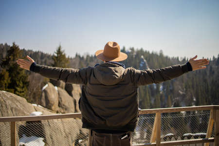 Man Traveler With A Raised Hands In The Pose Of A Winner On Top Of Mountain.の写真素材