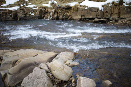 Top View Of Stones In A Mild River With A Reflection