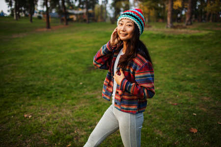 Cute Asian Teen Girl Posing Standing In Autumn Forest. Candid Woman In Hat Enjoying Autumn In The...
