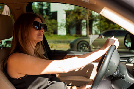 Young Blonde Attractive Woman Drive A Car n The Daytime