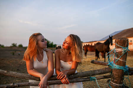 Fashion Portrait Photo Of Two Beautiful Young Blonde Women In Meadow On Natureの写真素材