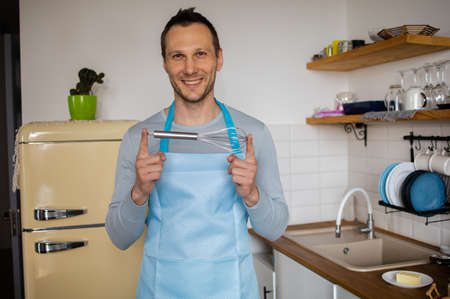 Portrait Of Male Chef Mixing Ingredients In Steel Bowlの写真素材