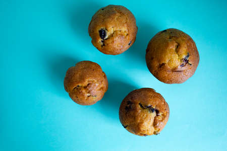 Blueberry And Vanilla Muffins Pastry Dessert Cake On Blue Background.の写真素材