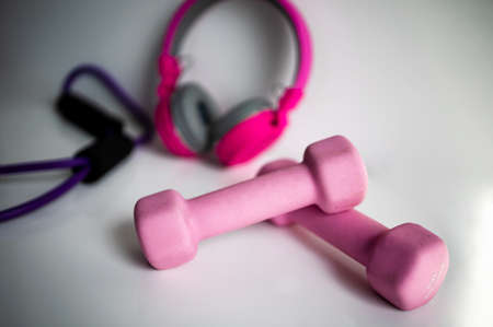 Pink Dumbbells And In-Ear Headphones. Sport And Fitnessの写真素材
