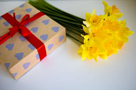 Gift Box And Bouquet Of Daffodils On White Backgroundの写真素材