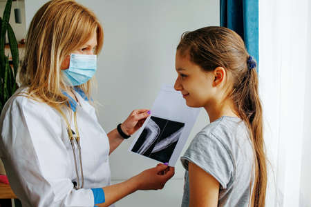 Positive Cute Girl Coming To Family Physician With Broken Armの写真素材