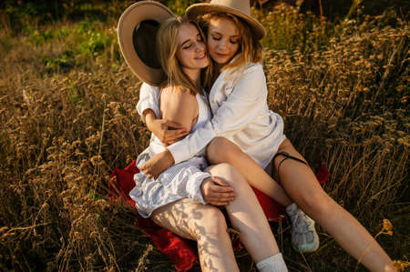 Young Pretty Blonde Women In Field Outdoor In Summer At Sunsetの写真素材