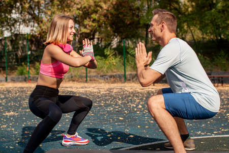 Young Cute Couple Exercising At The City Park. Outdoor Sportの写真素材