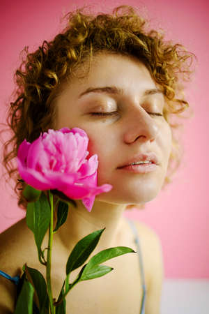 Young Attractive Lady Close Up With Flowers On Face Isolated On Pink Background.の写真素材