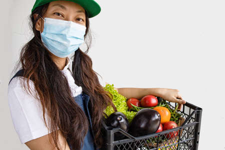 Food Delivery Woman With A Box Of Fresh Vegetablesの写真素材