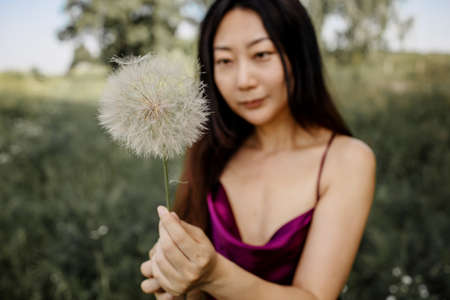 Allergy Free Concept. Asian Woman Blowing Dandelionの写真素材