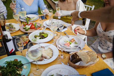 People At The Table At A Solemn Event Clink Glasses And Celebrateの写真素材