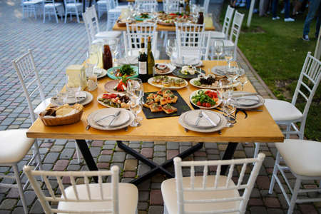 Served For Banquet Restaurant Table With Dishes, Snack, Wine Glassesの写真素材