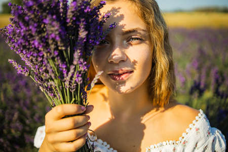 Portrait Of Pretty Young Woman Enjoying Sunlight In Lavender Fieldの写真素材