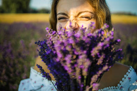 Portrait Of Pretty Young Woman Enjoying Sunlight In Lavender Field