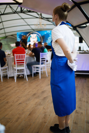 Waiter Female At Restaurant With Customersの写真素材