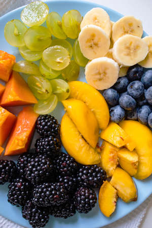 Salad Made From Fresh Summer Fruits On Blue Plate.の写真素材