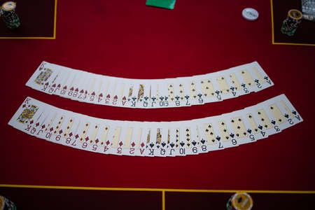 View On Poker Table With Cards And Chips In Low Ligh
