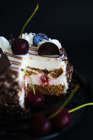Chocolate Brownie Cake With Cherries On A Black Background.