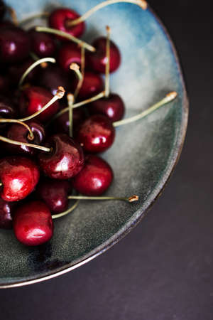Close-Up Red Sweet Cherries In A Dish On Kitchen Table Background