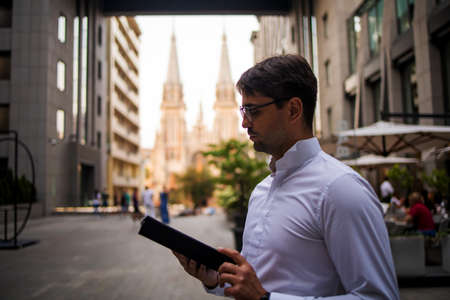 Handsome Businessman Using Tablet Outdoors In City.の写真素材
