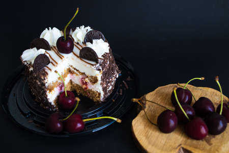 Chocolate Brownie Cake With Cherries On A Black Background.