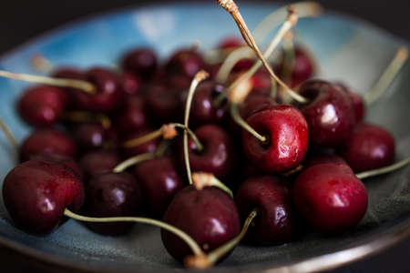 Close-Up Red Sweet Cherries In A Dish On Kitchen Table Background
