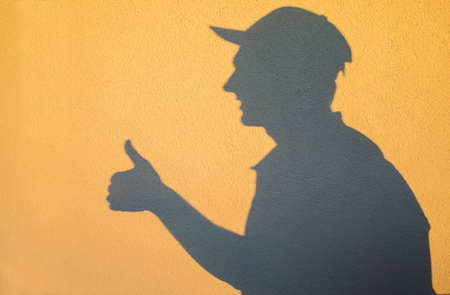 Silhouette of deliveryman in a cap At Sunsetの写真素材
