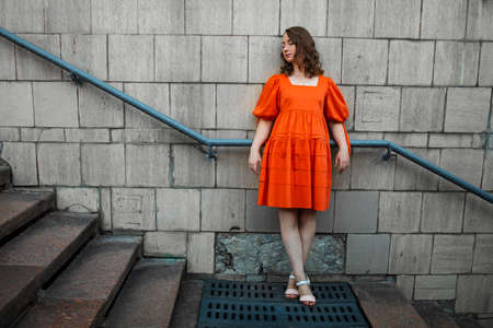 City Portrait Of pretty Woman Near Old Wallの写真素材