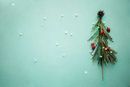 Christmas Tree made of Winter Foliage and leaves. Holiday Concept. Flat Lay, copy space.
