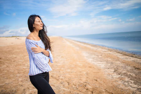 beautiful one sensual asian girl on the beach and be sad concept